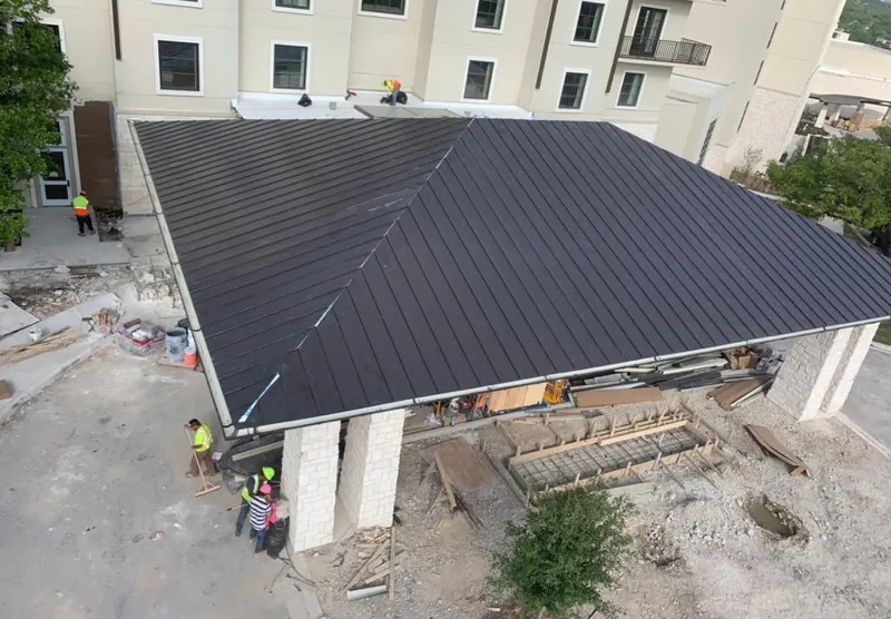 Metal roofing installation team working on a commercial building in Celebration